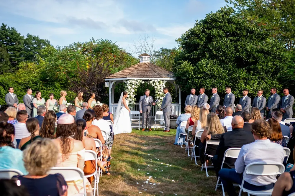 Guests seated for a ceremony at the gazebo